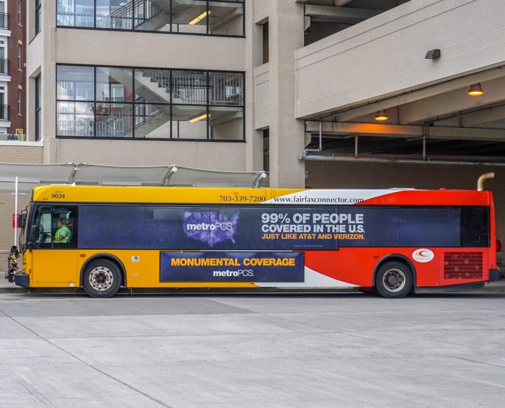 Yellow Colored Bus With Monumental Coverage Advertisement